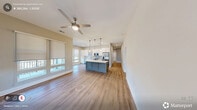 Located in the heart of Cary, NC, this well-appointed single-story home offers three bedrooms, two bathrooms, and a thoughtfully designed layout. The open-concept kitchen and living area serves as the social hub of the home, featuring white shaker cabinetry, quartz countertops, a subway tile backsplash, stainless steel appliances, and light wood-tone flooring that flows throughout the main living spaces. Roller shades and multi-pane windows invite natural light while offering views of the surrounding greenery.

The spacious primary bedroom is outfitted with plush carpet, a ceiling fan, and a generous bank of windows. Its en-suite bathroom impresses with a lengthy dual-sink vanity, white cabinetry with gold hardware, a large frameless mirror, and a separate walk-in shower. A well-organized walk-in closet with built-in shelving and hanging rods provides ample storage. The secondary bathroom includes a full soaking tub with tasteful tile surround and wood-look flooring. Additional bedrooms are carpeted and bright, each featuring large windows with roller shades. Six closets and a dedicated laundry room round out this clean, modern home with a neutral palette and high-quality finishes throughout.