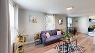 Located at 1603 Roane St in Richmond, VA, this two-floor, 2-bedroom, 1-bathroom home offers a well-organized and efficiently designed layout across two levels. The main floor houses the living room and kitchen, while the upper floor accommodates both bedrooms and the shared bathroom.

The living room is a bright, welcoming space featuring light wood-style flooring, soft gray walls, and multiple windows that fill the room with natural light. The kitchen is well-appointed with stainless steel appliances including a range, over-the-range microwave, dishwasher, and refrigerator, complemented by white cabinetry, granite-style countertops, and a window above the sink.

Upstairs, both bedrooms feature the same warm wood-style flooring and soft gray walls. The primary bedroom benefits from vaulted ceilings and a closet, with a window providing natural light and outdoor views. The second bedroom also features vaulted ceilings, a closet, and a window with outdoor views. The full bathroom includes a tub-shower combination with clean white surrounds. A hallway connects the upper-level rooms. Clean finishes, consistent flooring, and abundant natural light throughout give this home a cohesive, move-in-ready feel.