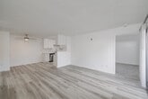 Located at 561 West San Ysidro Boulevard in San Diego, CA, this single-floor, 3-bedroom, 2-bathroom home offers a clean, modern aesthetic throughout. The combined dining and living area is an open, airy space finished with light-toned luxury vinyl plank flooring and a textured ceiling, anchored by a ceiling fan and filled with natural light from a sliding glass door that opens to a private patio. The kitchen is thoughtfully designed with white shaker cabinets, quartz countertops, recessed lighting, and stainless steel appliances including a refrigerator, range, and dishwasher. The galley-style layout maximizes efficiency while maintaining a bright, contemporary feel. The three bedrooms feature plush carpeting and windows with blinds that invite natural light. The primary bedroom offers a comfortable footprint with ample closet space. Both bathrooms are finished in a crisp, all-white palette; one includes a tub-shower combo with a lighted vanity mirror, while the other features a walk-in shower. Additional highlights include an in-unit laundry area and a wall-mounted A/C unit. The overall design is cohesive and neutral, making for a move-in-ready home in the heart of San Diego.