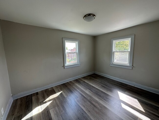 Large back bedroom with two windows and closet. - 738 Seymour Ave