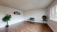 Located at 9016 Casals St in Sacramento, CA, this single-floor, 2-bedroom, 2-bathroom home offers a practical and well-organized layout. The spacious living room greets you upon entry, featuring warm wood-look flooring, neutral white walls, a textured ceiling, and a large front-facing window fitted with blinds that allow for ample natural light. The galley-style kitchen is efficiently designed with gray cabinetry, a white countertop with an integrated sink, and white appliances including a refrigerator, electric range, and dishwasher — all set on durable wood-look flooring. A connecting hallway leads to the two bedrooms, each finished with plush wall-to-wall carpeting, textured ceilings, and dedicated closets. The primary bedroom includes a ceiling fan and a window that brings in natural light. Both bathrooms are clean and functional, featuring gray vanity cabinetry, light countertops, and wood-look flooring. One bathroom includes a full tub and shower combination with white tile surround, while the other offers a vanity with mirror and towel bars. The home's straightforward single-level floor plan and consistent finishes throughout make it a comfortable and functional living space in Sacramento's 95826 area.