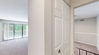 Located at 14023 Castle Blvd in Silver Spring, Maryland, this generously sized single-floor residence offers 3 bedrooms, 2 bathrooms, and an expansive, well-organized layout. The entrance leads into an open living area with neutral-toned carpet and a hallway connecting the home's key spaces. The kitchen is a standout feature, showcasing white shaker cabinetry, dark granite countertops, a grey subway tile backsplash, and light wood-style flooring. It is equipped with a gas range, refrigerator, dishwasher, and ample storage throughout. The two bathrooms are well-appointed — one features a clean white tub-shower combination, while the other includes a vanity with granite countertops and wood-style flooring with chrome fixtures. The three bedrooms are finished with plush carpet and neutral walls, allowing for natural light through slatted blinds. The primary bedroom offers a comfortable sense of scale, while secondary bedrooms provide flexible utility. A private deck off the unit overlooks a tranquil, tree-lined green space, adding a serene natural backdrop. Additional features include a dedicated closet and hallway for practical storage. The overall ambiance is clean, bright, and move-in ready.