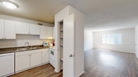 Located at 309 SW 16th Ave in Gainesville, Florida, this single-floor unit offers a straightforward and functional layout finished consistently throughout with wood-style flooring. The open living area is bright and spacious, benefiting from natural light filtering through vertical blinds and a textured ceiling that adds subtle visual interest overhead.

The kitchen is well-equipped with white cabinetry providing ample storage, dark stone-style countertops, a full suite of white appliances including a refrigerator, range, and dishwasher, and a built-in pantry closet for additional storage. The kitchen connects openly to the main living space, creating a practical flow.

The bedrooms are generously proportioned, each featuring wood-style flooring, ceiling fans with light fixtures, and windows dressed with vertical blinds that allow for natural light. At least one bedroom includes a dedicated closet with a double hanging rod for organized storage.

The bathroom is clean and functional, featuring a vanity with dark stone-style countertops, a medicine cabinet mirror, and a full tub-shower combination. White walls and wood-style flooring carry the unit's consistent aesthetic into this space as well. Overall, the unit presents a clean, neutral palette suited for comfortable everyday living.