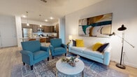 Located at 6101 Innovation Way in Tampa, Florida, this single-floor residence offers a thoughtfully designed open-concept layout that seamlessly connects the kitchen, living, and dining areas. The kitchen is a standout, featuring rich dark wood cabinetry, granite countertops, stainless steel appliances including a refrigerator, range, and microwave, and a central island with pendant lighting overhead — ideal for both cooking and casual dining. Wood-look flooring flows throughout the main living areas, adding warmth and continuity to the space. The living room is bright and inviting, highlighted by a ceiling fan, large windows that invite natural light, and a distinctive sliding barn door that adds a modern-rustic charm. A separate den or office space, also accessible via a barn door, provides flexible functionality. The bedrooms offer plush carpeting and generous natural light from large windows, creating a comfortable and restful retreat. The bathroom features a granite-topped vanity with dark wood cabinetry and a well-appointed mirror. Throughout the residence, clean white walls, contemporary finishes, and an open floor plan contribute to a fresh, modern ambiance that is both functional and visually appealing.