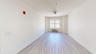 Located at 510 Hamilton St in Somerset, NJ, this one-bedroom, one-bathroom unit offers a well-designed layout with thoughtful finishes throughout. The kitchen is a standout feature, showcasing dark navy cabinetry with granite-style countertops, a classic subway tile backsplash, and a full suite of stainless steel appliances including a gas range, dishwasher, and refrigerator. A ventilation hood and recessed lighting complete the functional yet stylish space. Light wood-look tile flooring runs throughout the main living areas, lending a clean, contemporary feel to the open layout. The living area is bright and airy, featuring a ceiling fan and a window that allows natural light to fill the room. The bedroom is a comfortable size, finished with plush carpeting, a ceiling fan, and a window with outdoor views. A double-door closet provides ample storage within the bedroom. The bathroom is cleanly appointed with matching dark cabinetry, a single vanity with mirror, and wood-look tile flooring consistent with the rest of the unit. Neutral wall tones throughout create a calm, cohesive ambiance that is both modern and inviting, making this unit a practical and attractive living space in Somerset, New Jersey.