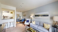 Located at 2 Abbott Dr in Hampton, Virginia, this two-story, one-bedroom, one-bathroom home is thoughtfully laid out across two floors. The main level features a welcoming living room with plush carpet flooring, large windows that invite natural light, and a neutral color palette that creates a warm, open ambiance. The kitchen is equipped with white cabinetry, dark granite-style countertops, a coil-top electric range, and a full-size refrigerator, all complemented by wood-look plank flooring. Ascending the staircase to the upper level, the generously sized primary bedroom offers soft carpet flooring, ample natural light from a large window, and direct access to a dedicated closet with hanging storage. The full bathroom features wood-look flooring, a tub-shower combination with tile surround, a vanity with sink, and neutral gray walls. A standout practical feature is the in-unit laundry area, which accommodates a full-size washer and dryer with built-in shelving above for added storage. Throughout the home, clean lines, light tones, and consistent finishes create a cohesive and comfortable living environment well-suited for everyday living.