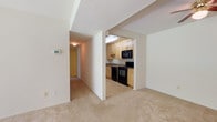 Located at 5 Maidstone Ct in Rosedale, Maryland, this single-floor residence offers a practical and comfortable layout designed for everyday living. The open living area is finished with neutral wall-to-wall carpeting and receives natural light through a sliding glass door that opens to a view of lush greenery, creating a welcoming and airy atmosphere throughout.

The kitchen is efficiently designed with light maple cabinetry, granite-style countertops, and a full suite of black appliances, including a range, over-the-range microwave, and dishwasher. Tile flooring and a ceiling light fixture complete the functional workspace.

A central hallway connects the main living area to the private rooms, each carpeted and finished in neutral tones with ample wall space. The bedrooms offer a quiet retreat, with one room featuring a window that allows natural light to filter in. Six-panel doors add a classic touch throughout.

The bathroom is clean and straightforward, featuring a full soaking tub with a tiled surround, a toilet, and neutral finishes. A programmable thermostat is conveniently located in the main living space, adding a modern comfort feature. The overall design is clean, understated, and move-in ready.