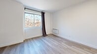 Located at 3777 Rue St-Urbain in Montreal's vibrant Mile End neighbourhood, this efficient one-bedroom, one-bathroom unit offers a thoughtfully organized single-floor layout. Light-toned laminate wood flooring runs throughout, creating a cohesive and airy feel across the entire space.

The main living area doubles as the bedroom, benefiting from multiple windows that frame views of surrounding trees and flood the room with natural light. A wall-mounted electric baseboard heater provides efficient climate control, while a floor-to-ceiling mirrored sliding closet adds both storage and the visual impression of additional depth.

The kitchen is neatly integrated along one wall, featuring white cabinetry with modern hardware, a marble-effect subway tile backsplash, a stainless steel sink, and a white electric range. A full-size refrigerator stands adjacent, maximizing the functionality of the compact cooking space.

The bathroom is finished in a clean, contemporary style with large-format marble-look wall tiles surrounding the full soaking tub and shower combination, complemented by beige floor tiles, a white vanity, and a wall mirror — creating a bright and polished feel.

Throughout, the crisp white walls, natural light, and consistent flooring give the unit a clean, modern character well-suited to urban living in one of Montreal's most walkable and lively districts.