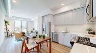 Located at 10401 Washington Blvd in Culver City, CA, this modern one-bedroom, one-bathroom residence offers a thoughtfully designed open-concept layout with clean lines and a bright, contemporary aesthetic throughout. Light wood flooring flows seamlessly across the main living areas, enhancing the sense of openness and warmth.

The kitchen is outfitted with sleek, floor-to-ceiling gray cabinetry, white countertops, and a full suite of stainless steel appliances, including a French door refrigerator, dishwasher, range, and microwave. It opens directly to the dining and living areas, creating an ideal space for everyday living and entertaining.

The living room is anchored by a large sliding glass door that fills the space with natural light and offers views of the surrounding Culver City skyline. An exposed metallic HVAC duct adds an industrial design touch to the otherwise minimalist space.

The bedroom is a calm retreat with a generous closet featuring sliding doors and easy access to the living area. The bathroom features a wide vanity with undermount sink, white quartz countertop, and modern fixtures in a clean, neutral palette.

Two hallways connect the rooms efficiently, contributing to the unit's smart and functional flow throughout.