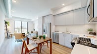Located at 10401 Washington Blvd in Culver City, CA, this modern one-bedroom, one-bathroom residence offers a thoughtfully designed open-concept layout with clean lines and a bright, contemporary aesthetic throughout. Light wood flooring flows seamlessly across the main living areas, enhancing the sense of openness and warmth.

The kitchen is outfitted with sleek, floor-to-ceiling gray cabinetry, white countertops, and a full suite of stainless steel appliances, including a French door refrigerator, dishwasher, range, and microwave. It opens directly to the dining and living areas, creating an ideal space for everyday living and entertaining.

The living room is anchored by a large sliding glass door that fills the space with natural light and offers views of the surrounding Culver City skyline. An exposed metallic HVAC duct adds an industrial design touch to the otherwise minimalist space.

The bedroom is a calm retreat with a generous closet featuring sliding doors and easy access to the living area. The bathroom features a wide vanity with undermount sink, white quartz countertop, and modern fixtures in a clean, neutral palette.

Two hallways connect the rooms efficiently, contributing to the unit's smart and functional flow throughout.