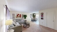 Located at 567 Sharp Ln in Baton Rouge, Louisiana, this single-floor, 2-bedroom, 2-bathroom home offers a practical and comfortable layout. The living room features neutral-toned carpet, a textured ceiling, and a window that brings in natural light, creating a warm and inviting atmosphere. It flows seamlessly into the dining area, which is anchored by a round marble-top table beneath a multi-bulb chandelier and a sliding glass door that opens to the outdoors, filling the space with additional light and outdoor views. A wall-mounted mirror enhances the sense of openness in the dining nook. The kitchen is equipped with warm wood cabinetry, ample upper and lower storage, a double sink, and white appliances including a range, dishwasher, and refrigerator. The primary bedroom offers carpeted flooring, a large window with drapes, dual closets, and a textured ceiling. The second bedroom is similarly appointed. Both bathrooms feature wood-toned vanities with white countertops and framed mirrors; one includes a shower-tub combination. A connecting hallway ties the layout together efficiently, making this a well-organized and functional home.