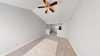 Located at 18290 Upper Bay Rd in Nassau Bay, TX, this single-story home offers four bedrooms, two bathrooms, a kitchen, hallway, entrance, and a closet within a compact yet functional floor plan. The standout architectural feature is the vaulted ceiling in the primary bedroom, which creates a dramatic sense of vertical space and openness. Soft neutral-toned carpet flows throughout the bedrooms, complemented by light gray walls and white trim that give the interior a clean, cohesive look. Each bedroom is equipped with a ceiling fan with integrated lighting, and several rooms feature windows that allow natural light and views of surrounding greenery. The spacious primary bedroom offers ample room and benefits from the soaring vaulted ceiling. The galley-style kitchen is well-appointed with white cabinetry, white countertops, a gas range, a dishwasher, a double-basin sink, and wood-look flooring, offering an efficient and bright cooking space. The two bathrooms include one with a tub-shower combination and a well-lit vanity with a large mirror, and another with a glass-door shower enclosure. The entrance features wood-look flooring, transitioning seamlessly into the rest of the home.
