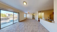 Located at 9745 Grand Teton Dr in Las Vegas, NV, this well-appointed 2-bedroom, 2-bathroom residence offers a thoughtfully designed single-level layout. The open-concept living, dining, and kitchen area forms the heart of the home, featuring plush carpeting, crown molding, and a ceiling fan. Sliding glass doors flood the space with natural light and open directly onto a private balcony with outdoor views.

The kitchen is a standout, boasting rich wood cabinetry, granite countertops, stainless steel appliances including a gas range and built-in microwave, wood-style flooring, and a peninsula with a sink — ideal for casual dining or entertaining. A pantry and dedicated laundry area add practical convenience.

Both bedrooms are carpeted and generously sized, with the primary bedroom featuring its own sliding glass door to the balcony and ample closet space, including a spacious walk-in closet with wire shelving. The second bedroom benefits from a large window with neighborhood views.

The bathrooms are finished with granite-topped vanities, rich wood cabinetry, and wood-style flooring. A hallway connects the bedrooms and bathrooms, completing this well-organized and comfortable home.