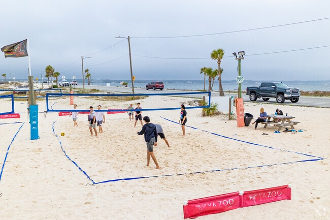 Cross the bridge for all the white sand activities, like beach volleyball in Navarre.