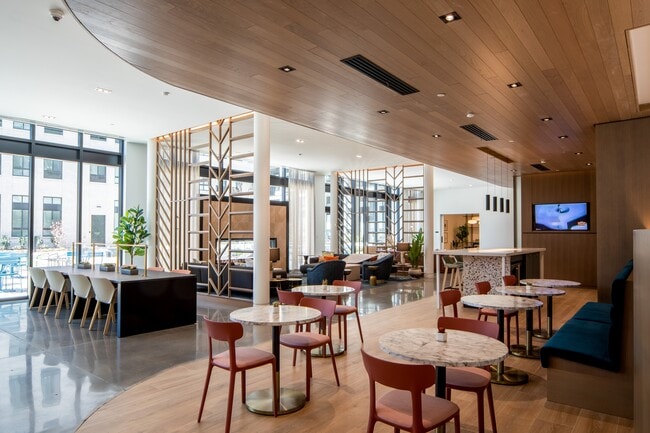 Our amenity core at Wellsmith includes a fireplace lounge, an entertainment kitchen, gaming tables and spaces to gather or work from home - Wellsmith Apartments