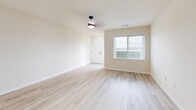 Located at 950 Canter Dr in Madison, WI, this well-designed 2-bedroom, 2-bathroom single-floor residence offers a clean, modern aesthetic throughout. The open-concept kitchen and living area serves as the heart of the home, featuring crisp white shaker cabinetry with matte black hardware, light quartz countertops, a full suite of stainless steel appliances including a range, microwave, dishwasher, and refrigerator, and pendant lighting accents. Light wood-look flooring runs throughout the main living areas, creating a bright and cohesive feel. The spacious living room benefits from natural light and a ceiling fan, while a hallway connects the main living space to the private quarters. Both bedrooms are generously sized, outfitted with soft plush carpeting, ceiling fans, and large windows that bring in ample natural light. The primary bedroom offers a comfortable footprint well-suited for a full furniture arrangement. The two bathrooms are finished with white vanities, matte black hardware, light wood-look flooring, and walk-in shower stalls. Each bathroom maintains the home's consistent modern and clean design language. Two closets provide practical storage solutions. The overall ambiance is fresh, bright, and move-in ready.