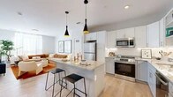 Located at 222 Canal St in New Haven, CT, this well-designed one-bedroom, one-bathroom residence offers a thoughtfully organized floor plan across a single level. The open-concept kitchen and living area serves as the heart of the home, featuring light hardwood flooring, white shaker-style cabinetry, and granite countertops. A central island with bar seating anchors the kitchen, illuminated by a pair of sleek black pendant lights. Stainless steel appliances, including a full-size refrigerator, range, and over-the-range microwave, complete the modern kitchen setup. The living area flows naturally from the kitchen, offering a comfortable gathering space filled with natural light from large windows. The spacious bedroom provides a serene retreat, with ample natural light, neutral carpet flooring, and a wall-mounted TV. A dedicated closet offers practical storage. The bathroom is clean and functional, featuring a single-vanity with white countertop, gray cabinetry with gold hardware, a large mirror, and a walk-in shower. Throughout the residence, a cohesive neutral palette and modern finishes create a bright, contemporary ambiance well-suited to urban living in New Haven.