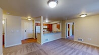 Located at 3755 Tutt Blvd in Colorado Springs, Colorado, this single-floor residence offers a well-organized, open-concept layout designed for comfortable everyday living. The living area is generously sized and finished with plush wall-to-wall carpeting, creating a warm and inviting atmosphere. A ceiling fan with integrated lighting adds both function and airflow to the space, while large sliding glass doors flood the room with natural light and provide direct access to a private balcony with outdoor views.

The kitchen is positioned centrally and features warm-toned wood cabinetry, a peninsula with counter seating, a full suite of white appliances, and a dual-basin sink — all laid out for efficient use and open sightlines to the living area. A dedicated utility area with matching wood cabinetry, generous counter space, and hardwood-style flooring provides additional storage and workspace.

The bathrooms are cleanly appointed, with one featuring a full tub-shower combination and hardwood-style flooring, and another offering a tub with a curtain rod and straightforward, functional fixtures. Bedrooms are carpeted and well-proportioned, with windows fitted with vertical blinds for light control. The entryway is finished with hardwood-style flooring, providing a clean transition into the main living spaces.