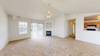 Located at Magnolia Run in Virginia Beach, VA, this single-floor residence offers three bedrooms and three bathrooms within a thoughtfully arranged floor plan. The spacious living room serves as the centerpiece of the home, showcasing vaulted ceilings with a ceiling fan, plush carpeting, and a fireplace flanked by a built-in niche. Sliding glass doors flood the space with natural light and provide outdoor access, while an adjacent window further enhances brightness throughout.

The kitchen features light wood cabinetry with ample storage, white countertops, and durable hardwood-style flooring. It is equipped with black appliances, including a refrigerator, electric range, and dishwasher, offering functional efficiency.

The generously sized primary bedroom benefits from vaulted ceilings and a walk-in closet outfitted with wire shelving for organized storage. The additional bedrooms are carpeted, well-lit by windows with outdoor views, and include ceiling fans. A dedicated laundry room houses a full-size Whirlpool washer and dryer. Three bathrooms serve the household, completing this practical and comfortable Virginia Beach residence.