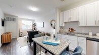 Located at 28 Southfield Ave in Stamford, Connecticut, this well-appointed one-bedroom, one-bathroom residence offers a thoughtfully designed single-floor layout. The open-concept living and kitchen area serves as the heart of the home, where rich wood-style flooring flows seamlessly throughout, creating a warm and cohesive aesthetic. The kitchen is a standout feature, showcasing crisp white shaker cabinetry extending to the ceiling, granite countertops, a granite-topped island with bar seating, and a full suite of stainless steel appliances including a gas range, dishwasher, microwave, and refrigerator. Natural light filters in through windows in the living area, which offers comfortable space for both relaxing and dining. The bedroom is a calm retreat with neutral tones, ample room for a full furniture arrangement, and access to a dedicated walk-in closet. Two additional closets provide generous storage throughout the residence. The bathroom features a white vanity with an undermount sink, a tub-shower combination, and clean, modern finishes. An in-unit laundry area adds everyday convenience. With three closets total and a practical, efficient floor plan, this residence delivers modern comfort in a desirable Stamford location.