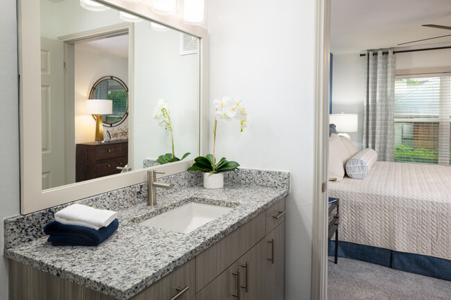 Wood grain cabinets and framed mirrors - Montelena Apartments