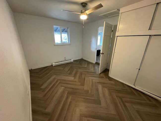 Private bedroom with built-in closet, ceiling fan, and baseboard heat - 1718 E Abriendo Ave