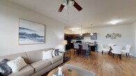 Located at 1809 Meeting St in Lexington, KY, this single-floor residence offers a thoughtfully designed open-concept layout that seamlessly connects the living, dining, and kitchen areas. Rich hardwood-style flooring flows throughout the main living spaces, complemented by neutral tones and abundant natural light streaming through large windows with blinds. Ceiling fans are present throughout, adding both function and style.

The spacious living room features vaulted ceilings, large windows, and ample room for comfortable seating arrangements. It opens directly to the kitchen, which is outfitted with dark espresso cabinetry, granite-style countertops, black appliances including a refrigerator, range, built-in microwave, and dishwasher, as well as a double-basin sink and a decorative wine rack built into the upper cabinetry. A kitchen island with bar seating provides an ideal space for casual dining.

The bedrooms are generously sized, each with ceiling fans, windows that invite natural light, and carpeted or hardwood-style flooring. Both full bathrooms feature dark vanity cabinetry with granite-style countertops, hardwood-style flooring, and full tub-shower combinations. The overall ambiance is clean, contemporary, and inviting, offering a comfortable and functional living environment.