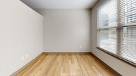 Located at 9938 Trainstation Cir in Lone Tree, Colorado, this efficient single-floor unit offers a well-organized layout comprising a living room, one bedroom, a closet, and a kitchen. Throughout the space, light hardwood-style flooring creates a warm, cohesive aesthetic that flows seamlessly from room to room.

The living area is bright and open, featuring multiple windows fitted with horizontal blinds that allow ample natural light to filter in. Neutral, warm-toned walls complement the light flooring and contribute to an airy, clean atmosphere. A ceiling fan is visible in the living space, adding both functionality and a subtle design element.

The kitchen is equipped with dark cabinetry, stainless steel appliances including a refrigerator, microwave, and range, along with a sink and countertop workspace — making efficient use of the available footprint.

The bedroom is a cozy, well-proportioned room with a window that brings in natural light, continuing the same hardwood-style flooring and neutral wall palette seen throughout the unit. A dedicated closet provides practical storage.

Modern conveniences such as a smart thermostat and thoughtfully placed electrical outlets are integrated throughout. The overall design is clean and contemporary, making this a highly functional space well-suited for efficient everyday living in the Lone Tree area.