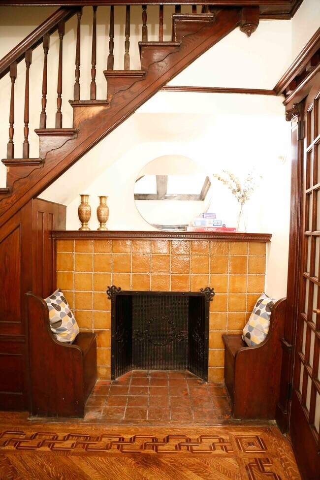 Decorative fire place with built in benches in the parlor - 352 Parkside Ave