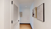 Located on the 16th floor at 930 McCarter Hwy in Newark, NJ, this well-appointed one-bedroom, one-bathroom residence offers a thoughtfully designed layout across a single floor. The living room is bathed in natural light from a large floor-to-ceiling sliding glass door that frames striking panoramic views of the Newark skyline, complemented by warm hardwood flooring and crisp white walls that create a bright, airy ambiance throughout.

The kitchen is a standout feature, showcasing natural wood upper cabinetry paired with sleek slate-gray lower cabinets, a bold blue ceramic tile backsplash, white quartz countertops, and a full suite of stainless steel appliances including a range, over-the-range microwave, and dishwasher.

The bedroom is a serene retreat, highlighted by oversized windows offering expansive city views, hardwood floors, and access to a dedicated closet with built-in shelving. The bathroom continues the design-forward aesthetic with floor-to-ceiling deep blue subway tile surrounding a soaking tub, accented by matte black fixtures. A hallway connects the rooms efficiently, rounding out this cohesive and stylish urban residence.