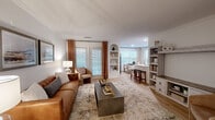 Located at 1000 Avonlea Pl in Woodstock, GA, this well-appointed 2-bedroom, 2-bathroom single-floor residence offers a thoughtfully designed layout with an abundance of natural light and stylish finishes throughout. The open-concept living, dining, and kitchen area serves as the heart of the home, featuring light hardwood-style flooring, crown molding, and large windows dressed with elegant drapes. A built-in arched shelving unit adds architectural character to the living space, while the kitchen impresses with rich wood cabinetry, white countertops, stainless steel appliances, and a breakfast bar with counter seating. The dining area is bathed in natural light from corner windows and offers a warm, inviting atmosphere. The spacious primary bedroom includes a ceiling fan and access to a generously sized walk-in closet with wire shelving. The bathrooms are clean and functional, with the primary bath featuring a glass-enclosed shower, wood-toned vanity, and hardwood-style flooring. Five closets throughout provide exceptional storage. A dedicated laundry room and a private patio round out the home's practical amenities, making this residence a comfortable and functional retreat in Woodstock, GA.
