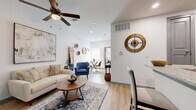 Located at 4100 Preferred Place in Dallas, TX, this single-floor residence offers 2 bedrooms, 2 bathrooms, and a thoughtfully organized layout. Light wood flooring runs throughout, lending warmth and visual continuity across all rooms.

The open-concept living, dining, and kitchen area forms the heart of the home. The living room features vaulted ceilings with a ceiling fan, recessed lighting, and a bright, neutral color palette. The kitchen is equipped with gray shaker-style cabinetry, granite countertops, stainless steel appliances, a subway tile backsplash, and a peninsula with bar seating—ideal for casual dining. A dedicated dining area sits adjacent, completing the cohesive shared space.

The primary bedroom is generously proportioned, offering a ceiling fan, a window with natural light, and ample closet space. The second bedroom is bright and comfortable, featuring a window and a double sliding closet. Both bathrooms are finished with gray vanity cabinetry, granite countertops, framed mirrors, and wood-look flooring. The unit also includes a dedicated laundry area and three closets for additional storage. The clean, modern finishes and efficient layout make this a functional and inviting residence.