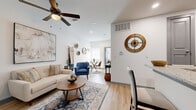 Located at 4100 Preferred Place in Dallas, TX, this single-floor residence offers 2 bedrooms, 2 bathrooms, and a thoughtfully organized layout. Light wood flooring runs throughout, lending warmth and visual continuity across all rooms.

The open-concept living, dining, and kitchen area forms the heart of the home. The living room features vaulted ceilings with a ceiling fan, recessed lighting, and a bright, neutral color palette. The kitchen is equipped with gray shaker-style cabinetry, granite countertops, stainless steel appliances, a subway tile backsplash, and a peninsula with bar seating—ideal for casual dining. A dedicated dining area sits adjacent, completing the cohesive shared space.

The primary bedroom is generously proportioned, offering a ceiling fan, a window with natural light, and ample closet space. The second bedroom is bright and comfortable, featuring a window and a double sliding closet. Both bathrooms are finished with gray vanity cabinetry, granite countertops, framed mirrors, and wood-look flooring. The unit also includes a dedicated laundry area and three closets for additional storage. The clean, modern finishes and efficient layout make this a functional and inviting residence.
