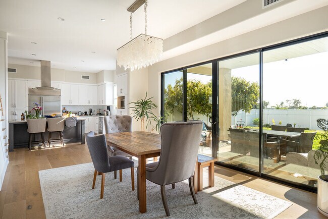 Open concept dining room with access to kitchen and large sliders to backyard - 3687 Valley St