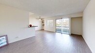 Located at 9150 Tampa Ave in Northridge, Los Angeles, this one-bedroom, two-bathroom unit offers a well-organized single-floor layout. Light wood-style flooring runs throughout, complementing the bright, neutral palette found in every room.

The galley-style kitchen features white shaker cabinetry, dark stone countertops, a classic subway tile backsplash, and a full suite of stainless steel appliances, including a refrigerator, dishwasher, range, and over-the-range microwave. An open pass-through connects the kitchen to the living area.

The spacious living room is filled with natural light from large sliding glass doors that open onto a private balcony with outdoor views. A ceiling fan adds comfort, and a dedicated window with blinds provides additional ventilation. The living area flows openly, offering flexible arrangements for furniture.

The bedroom is a comfortable size, featuring a mirrored sliding-door closet, a window with blinds, and a wall-mounted HVAC unit. Two additional closets provide generous storage throughout the unit.

Both bathrooms are finished in clean, all-white fixtures, with one featuring a full soaking tub and shower combination. The overall ambiance is bright, clean, and functional, suited for everyday living in the heart of the San Fernando Valley.
