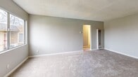 Located at 2800 Gentrytown Dr in Antioch, CA, this 2-bedroom, 1-bathroom single-floor unit offers a practical and well-organized layout. The entrance leads into a bright living room featuring neutral gray walls, plush carpeting, a textured ceiling, and a wall-mounted HVAC unit for climate control. Adjacent to the living area is a compact kitchen equipped with white cabinetry, a gas range, dishwasher, refrigerator, and a sink with ample counter space — all finished with wood-look flooring. A sliding glass door in the kitchen area brings in natural light and provides outdoor access. The two bedrooms are carpeted and feature neutral tones, textured ceilings, and windows that let in natural light with neighborhood views. The primary bedroom offers a comfortable, well-proportioned space. The bathroom includes a full tub-shower combination with tiled surround, a vanity with a marble-style countertop, and wood-look flooring. A hallway connects the bedrooms and bathroom, keeping the layout functional. Overall, the unit presents a clean, move-in ready aesthetic with consistent neutral finishes throughout.
