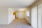 Located at 8711 Contee Rd in Laurel, MD, this single-story home offers a well-organized layout across three bedrooms, two bathrooms, and multiple closets. The open living and dining area is generously sized, featuring soft neutral carpeting, warm beige tones, and a pendant light fixture overhead. A sliding glass door floods the space with natural light and provides direct access to the outdoors, offering a pleasant view of the surrounding greenery. The living area connects seamlessly to the dining space, creating an open, cohesive flow throughout.

The kitchen is equipped with light wood cabinetry, dark countertops, tile flooring, and stainless steel appliances including a refrigerator and over-the-range microwave, offering both functionality and style. A hallway connects the main living area to the private quarters.

The spacious primary bedroom features plush carpeting and ample room for furnishings. It is complemented by a generous walk-in closet with built-in shelving. The additional bedrooms are well-proportioned with soft carpet and natural light. Both bathrooms are clean and bright, with the full bath featuring a tub-shower combo, a wood-vanity, white tile flooring, and a round decorative mirror. Three closets throughout the home ensure abundant storage.
