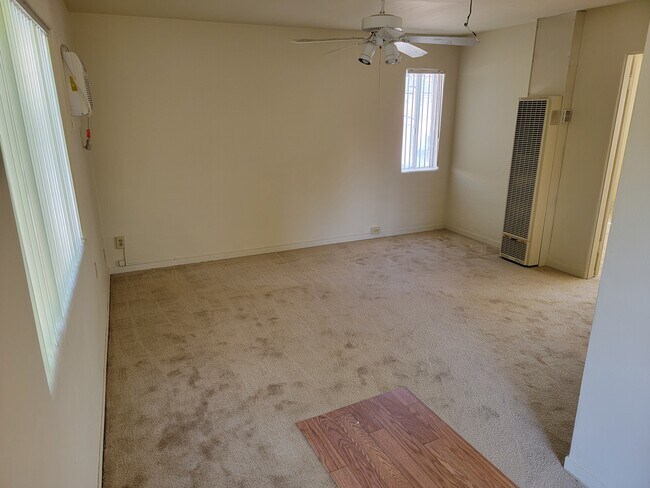 Living room with new carpet, paint and vertical blinds - 424 W Badillo St
