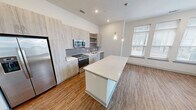 This contemporary apartment in Herndon, VA offers 1190 square feet of thoughtfully designed living space. The single-floor layout comprises three bedrooms, including a 140 sq ft primary bedroom, and two full bathrooms. The heart of the home is an open-concept kitchen and living area, showcasing a sleek design with light wood cabinetry, stainless steel appliances, and a subway tile backsplash. The kitchen island doubles as a breakfast bar, perfect for casual dining.

Throughout the apartment, warm wood-look flooring creates a cohesive and inviting atmosphere. Large windows in the bedrooms and living areas flood the space with natural light, while providing views of the surrounding area. The bathrooms feature modern fixtures, including double vanities and ample counter space.

Storage is abundant, with walk-in closets in the bedrooms and additional closet space in the hallway. The apartment's neutral color palette and clean lines offer a blank canvas for personalization. Recessed lighting and stylish fixtures add to the contemporary ambiance. This well-appointed apartment combines functionality and style, ideal for modern urban living.