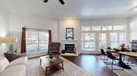 Located at 1101 Texas St in Fort Worth, TX, this single-story, 3-bedroom, 2-bathroom home offers a well-designed layout across a comfortable footprint. The living room serves as the heart of the home, featuring soaring ceilings, rich dark hardwood floors, a classic white-mantled fireplace, and multiple large windows that flood the space with natural light. French doors provide additional brightness and outdoor access.

The kitchen is open and functional, highlighted by granite countertops, a breakfast bar with seating, warm oak cabinetry, a dark slate subway tile backsplash, a tray ceiling, and stainless steel appliances. Built-in shelving near the kitchen adds both storage and display space.

The primary bedroom is generously sized with plush carpeting, a large window with outdoor views, and a ceiling fan. The secondary bedrooms also feature carpet flooring, closets, and vaulted ceiling lines. Both bathrooms are well-appointed with oak vanities, tub-shower combinations, and tile surrounds.

Additional spaces include two hallways, three closets, a utility room, and a dedicated entrance. The overall ambiance is warm and inviting, blending classic design elements with practical, comfortable living in a central Fort Worth location.