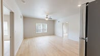 Located at 1000 Faceville Hwy in Bainbridge, Georgia, this single-story 2-bedroom, 2-bathroom home offers a clean, modern design with thoughtful finishes throughout. Light wood-tone flooring flows continuously across the entire home, creating a cohesive and bright atmosphere. The open living area features neutral-toned walls, a ceiling fan with light fixture, and a window that brings in natural light with views of surrounding greenery.

The kitchen is well-equipped with dark shaker-style cabinetry, granite countertops, a stainless steel sink, and a full suite of stainless steel appliances including a refrigerator, range, and microwave. The kitchen opens directly to the main living space, supporting an easy, connected flow.

The spacious primary bedroom includes a ceiling fan, a wall-mounted mini-split HVAC unit for individual climate control, and a window with blinds for natural light. It connects to a walk-in closet outfitted with wire shelving along multiple walls. The second bedroom offers a cozy footprint with the same warm wood flooring and neutral walls.

Both bathrooms are finished with dark wood vanities, granite countertops, and backlit LED vanity mirrors for a contemporary touch. One bathroom includes a full tub-shower combination, while both feature clean, modern fixtures. A hallway connects the rooms efficiently, and two closets provide ample storage throughout the home.
