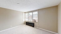 Located at 4817 N Knoxville Ave in Peoria, IL, this two-bedroom, one-bathroom unit offers a straightforward single-floor layout designed for comfortable everyday living. The interior is finished in warm neutral tones throughout, with light carpet covering the living areas and bedrooms, and clean white trim accenting the walls.

The generously sized primary bedroom is one of the standout features of the unit, providing ample space for furnishings and featuring a ceiling fan with light fixture, a closet, and a window that brings in natural light. The second bedroom also includes a ceiling fan and window, maintaining a consistent, comfortable feel.

The living area is open and welcoming, with a large window, a wall-mounted air conditioning unit, and a baseboard heating system — practical features suited to the Illinois climate. Natural light filters in through multiple windows fitted with blinds throughout the unit.

The kitchen features dark cabinetry contrasted against light countertops, a double-basin sink beneath a window overlooking the exterior, and tile flooring — offering a functional and efficient workspace. The bathroom includes a shower/tub combination and a window for ventilation.

Overall, this unit presents a clean, functional layout with consistent finishes, making it a practical and accessible option in the Peoria area.