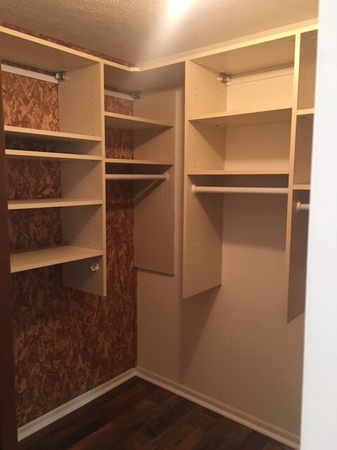 Walk in master closet with cedar walls, custom shelving, and laminate flooring. - 9660 Windjammer