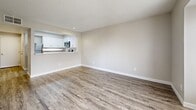 Located at 2864 Dublin Blvd in Colorado Springs, CO, this efficiently designed single-floor unit makes excellent use of its compact footprint. The open-concept living and dining area serves as the heart of the space, featuring durable wood-style plank flooring in a soft gray tone, neutral warm-beige walls, and a textured ceiling that adds subtle character. Natural light flows in through multiple windows fitted with horizontal blinds, creating a bright and inviting atmosphere. A door provides direct access to an outdoor area, enhancing the sense of openness.

The kitchen is thoughtfully designed with a pass-through window connecting it to the living area. White shaker-style cabinetry pairs with marble-look countertops, while stainless steel appliances — including a refrigerator, range, microwave, and dishwasher — provide a modern, functional workspace. The same wood-style flooring continues seamlessly throughout.

A connecting hallway leads to two bathrooms, one featuring a clean white tub-shower combination with a brushed nickel grab bar. The utility room houses a stacked washer and dryer unit, offering convenient in-unit laundry. A dedicated closet provides additional storage. The overall aesthetic is clean, modern, and move-in ready.