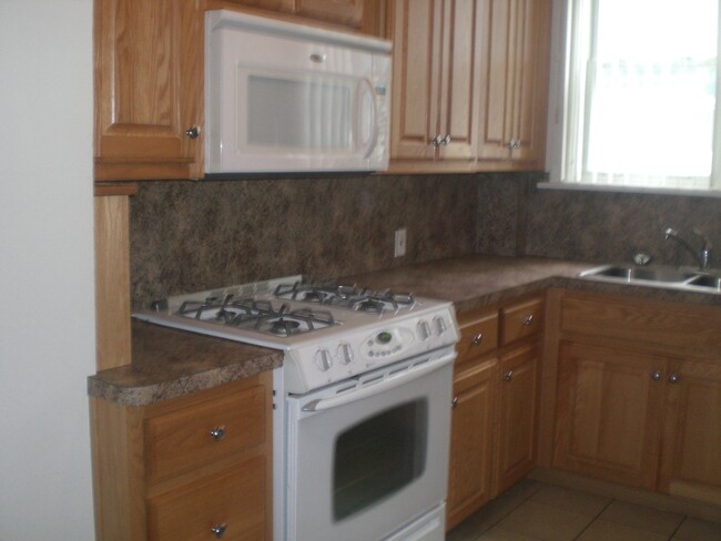 kitchen stove microwave counters,sink and cabinets - 18519 Chagrin Blvd