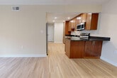 Located at 628 St Andrews Lane in Newport News, VA, this single-floor home offers three bedrooms and one bathroom within a thoughtfully organized layout. Light-toned hardwood flooring runs consistently throughout the space, lending a clean, cohesive feel to every room.

The open-concept kitchen and living area serves as the heart of the home. The kitchen is well-appointed with warm-toned wood cabinetry reaching to the ceiling, dark granite countertops, a peninsula with additional counter space, and a full suite of stainless steel appliances including a range, over-the-range microwave, dishwasher, and refrigerator. Recessed lighting illuminates the kitchen, while the adjacent living area benefits from natural light entering through the front entry.

The primary bedroom is a comfortable size, featuring a ceiling fan, a window with exterior views, and access to a dedicated walk-in closet with wire shelving. The additional bedrooms are well-proportioned, each with natural light from windows fitted with blinds and closet access. The full bathroom includes a standard tub-shower combination. A utility room and hallway complete the functional layout of this efficiently designed home.
