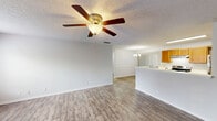 This single-story, 3-bedroom, 2-bathroom home in Birmingham, Alabama is designed for comfortable, everyday living. The open-concept layout seamlessly connects the kitchen and living room, creating a spacious and cohesive common area. The living room features soft carpeting, a ceiling fan with light fixture, and a sliding glass door that brings in natural light and provides outdoor access. A second ceiling fan in the dining area is complemented by a chandelier, adding a touch of character to the space.

The kitchen is well-equipped with warm wood cabinetry, white countertops, a stainless steel refrigerator, an electric range, and a dishwasher. Wood-look flooring ties the kitchen together, contrasting nicely with the carpeted living areas.

The primary bedroom is generously sized with a walk-in closet outfitted with wire shelving for organized storage. The additional bedrooms are carpeted and well-lit, with windows offering views of the surrounding greenery. The two bathrooms include tiled tub-shower combinations with chrome fixtures.

A dedicated laundry area and four closets throughout the home provide practical storage solutions. The textured ceilings and neutral color palette throughout create a clean, move-in ready environment.