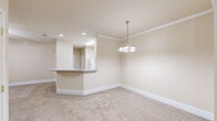 Located at 121 Margie Dr in Warner Robins, Georgia, this single-story, 3-bedroom, 1-bathroom home offers a comfortable and functional layout. The open-concept living area flows seamlessly into the kitchen, which features white cabinetry, a peninsula countertop, and recessed lighting — creating an inviting hub for daily living. Ceiling fans are present throughout the home, ensuring year-round comfort in every room.

The generously sized primary bedroom provides an expansive retreat, with plush carpeting, a ceiling fan, and direct access to a well-organized walk-in closet outfitted with multi-level wire shelving for ample storage. The two additional bedrooms are carpeted and bright, each featuring ceiling fans and windows with blinds that allow natural light while maintaining privacy. Each bedroom also benefits from dedicated closet space.

The bathroom is thoughtfully designed, featuring both a soaking tub and a separate glass-enclosed shower, with a glass block window that diffuses natural light while preserving privacy. Throughout the home, neutral warm-toned walls and clean white baseboards contribute to a cohesive, move-in-ready aesthetic. A hallway connects the bedrooms efficiently, and the overall layout maximizes the home's well-proportioned single-floor footprint.