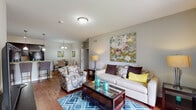 Located at Reserve Road in Lexington, Kentucky, this single-floor 2-bedroom residence offers a thoughtfully designed layout with a comfortable and modern aesthetic. The open-concept living area serves as the heart of the home, featuring warm hardwood flooring, neutral gray walls, and a welcoming ambiance. A glass-top coffee table and stylish furnishings complement the space, which flows seamlessly into a dedicated dining area illuminated by a decorative chandelier — ideal for everyday meals or entertaining.

The kitchen is well-equipped with rich dark cabinetry, granite-style countertops, a tile backsplash, and black appliances including a range, microwave, and refrigerator. Pendant lighting and recessed fixtures brighten the workspace, while hardwood floors continue throughout.

The primary bedroom offers a serene retreat with soft neutral tones and plush carpeting, while the second bedroom benefits from natural light through a large window and similarly comfortable carpeted flooring. Both rooms provide a calm, restful atmosphere.

Two bathrooms serve the residence, each featuring dark wood vanities with granite countertops and tub-shower combinations. The overall design is cohesive and functional, making this Lexington residence a practical and inviting place to call home.