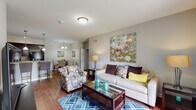 Located at Reserve Road in Lexington, Kentucky, this single-floor 2-bedroom residence offers a thoughtfully designed layout with a comfortable and modern aesthetic. The open-concept living area serves as the heart of the home, featuring warm hardwood flooring, neutral gray walls, and a welcoming ambiance. A glass-top coffee table and stylish furnishings complement the space, which flows seamlessly into a dedicated dining area illuminated by a decorative chandelier — ideal for everyday meals or entertaining.

The kitchen is well-equipped with rich dark cabinetry, granite-style countertops, a tile backsplash, and black appliances including a range, microwave, and refrigerator. Pendant lighting and recessed fixtures brighten the workspace, while hardwood floors continue throughout.

The primary bedroom offers a serene retreat with soft neutral tones and plush carpeting, while the second bedroom benefits from natural light through a large window and similarly comfortable carpeted flooring. Both rooms provide a calm, restful atmosphere.

Two bathrooms serve the residence, each featuring dark wood vanities with granite countertops and tub-shower combinations. The overall design is cohesive and functional, making this Lexington residence a practical and inviting place to call home.